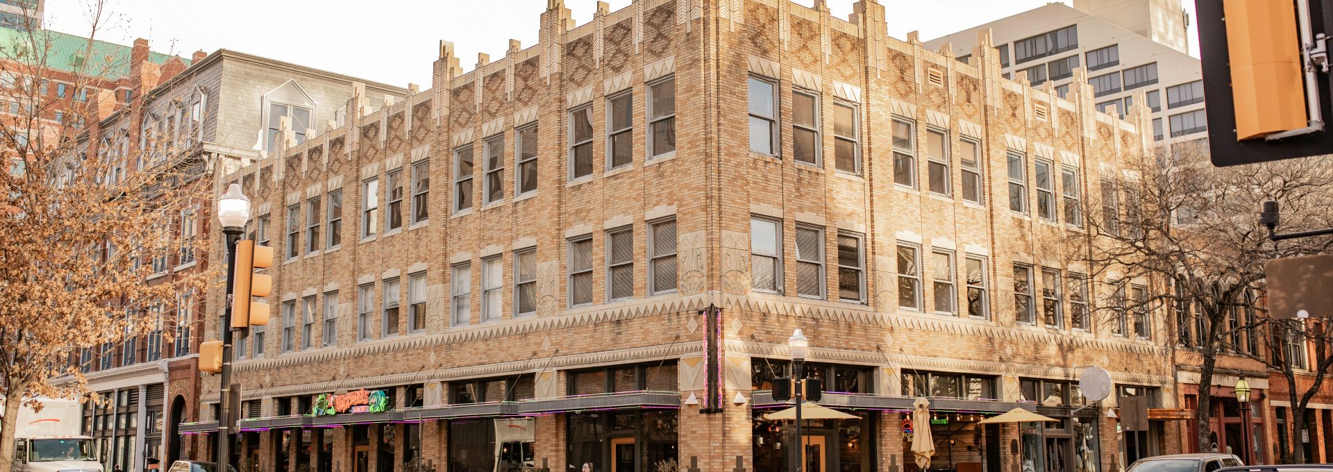 a city street with cars parked on the side of the road