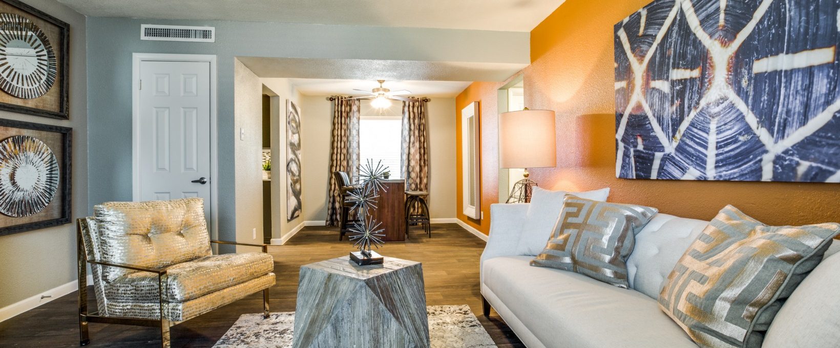 a living room with orange walls and white furniture at The Zeke