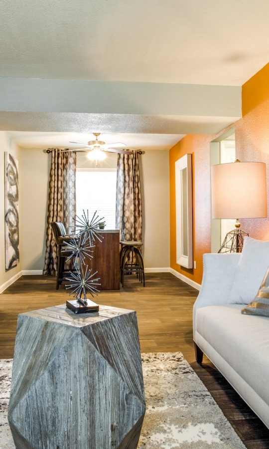 a living room with orange walls and white furniture at The Zeke