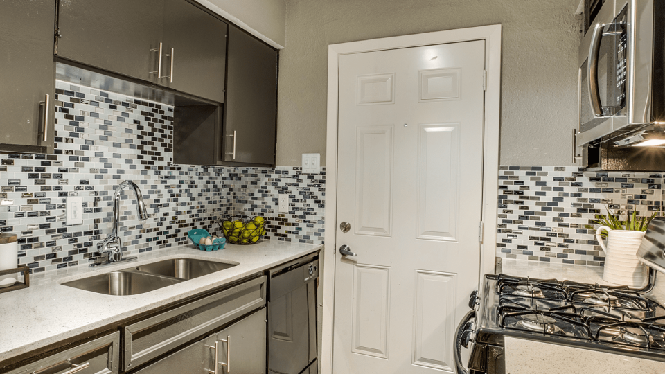 a kitchen with a sink, stove, and refrigerator at The Zeke
