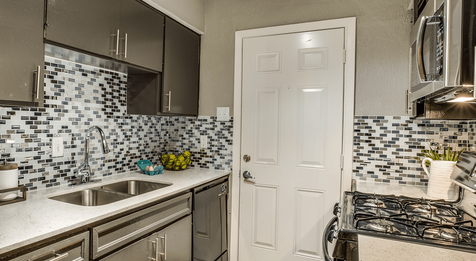 a kitchen with a sink, stove, and refrigerator at The Zeke
