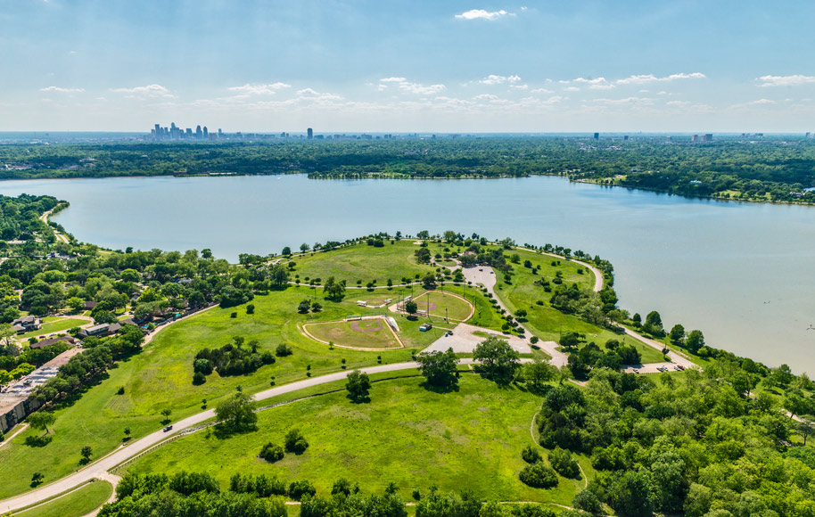 an aerial view of a park and lake at The Zeke