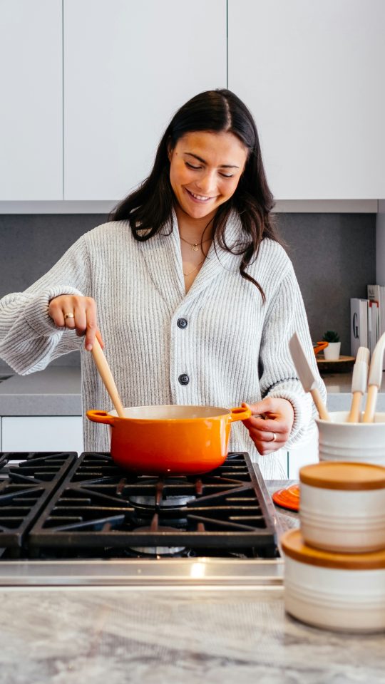 woman cooking inside kitchen room