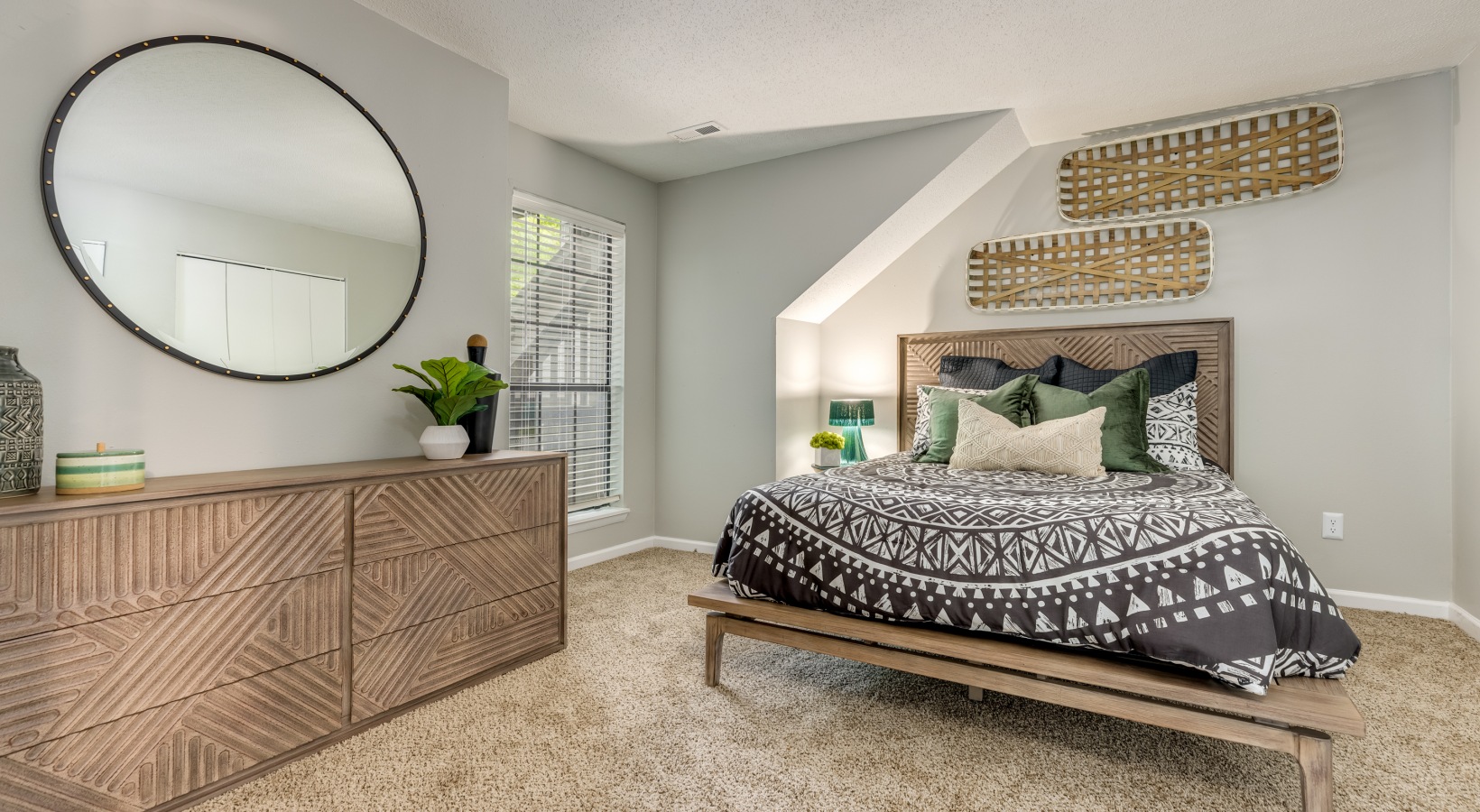 a bedroom with a large bed and a mirror at The Quinn on Ravenglass