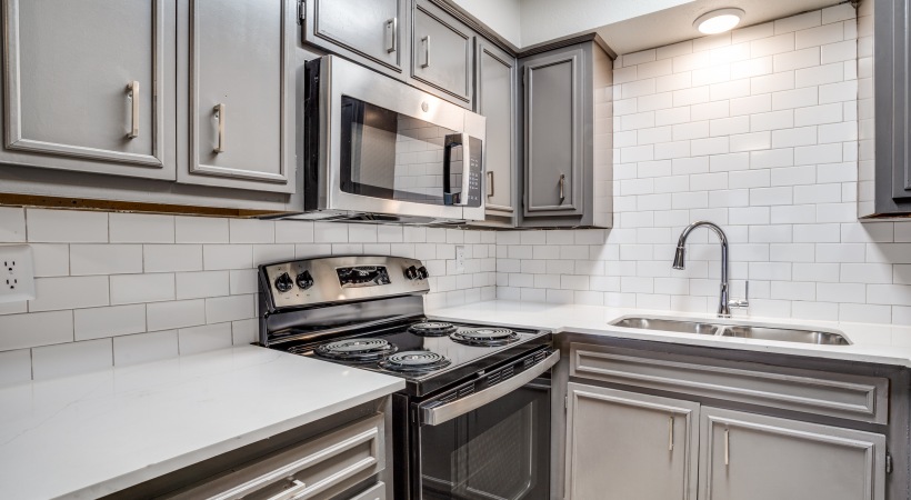 a kitchen with stainless steel appliances and gray cabinets at The Las Ventanas