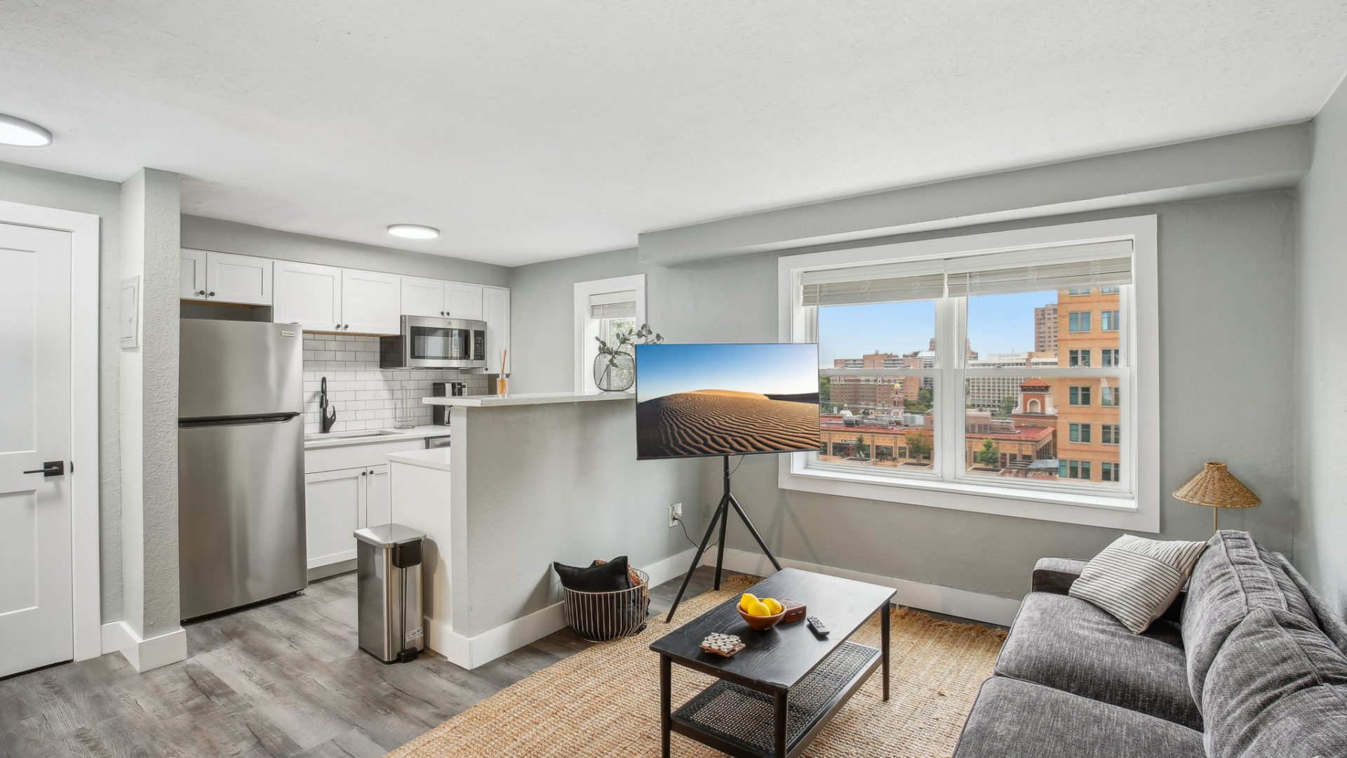 a living room with a couch, coffee table and television at The Broadway 46 Apartments