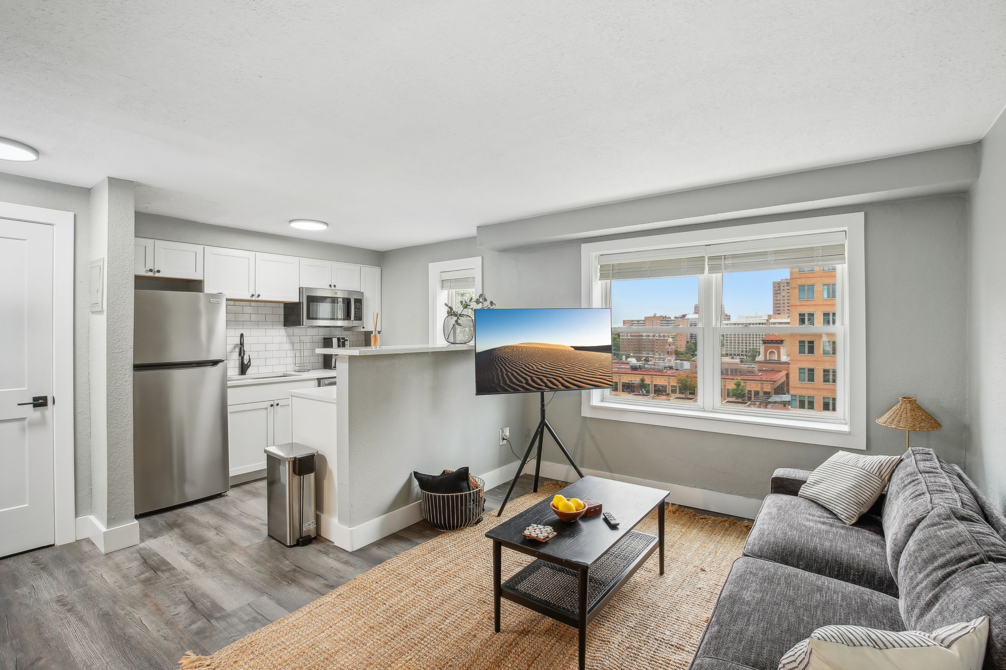 a living room with a couch, coffee table and television at The Broadway 46 Apartments