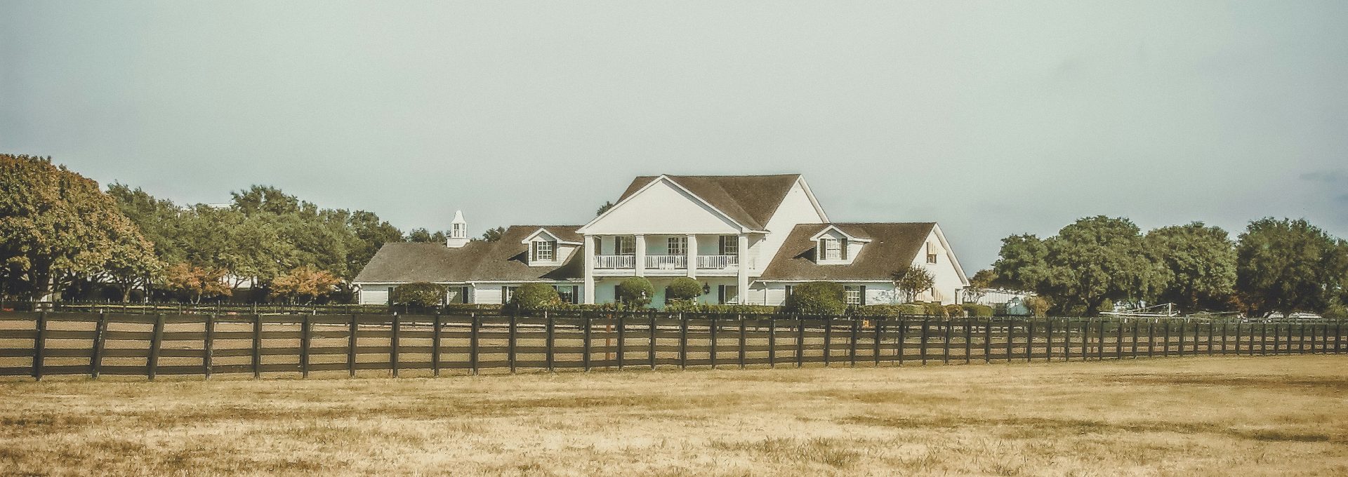 white 2-story house near green trees