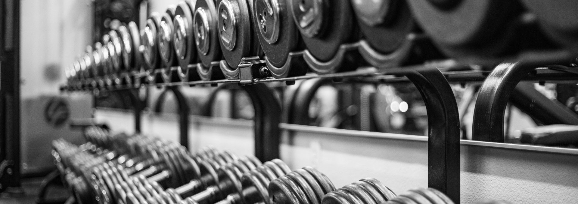 gray scale photo of dumbbells