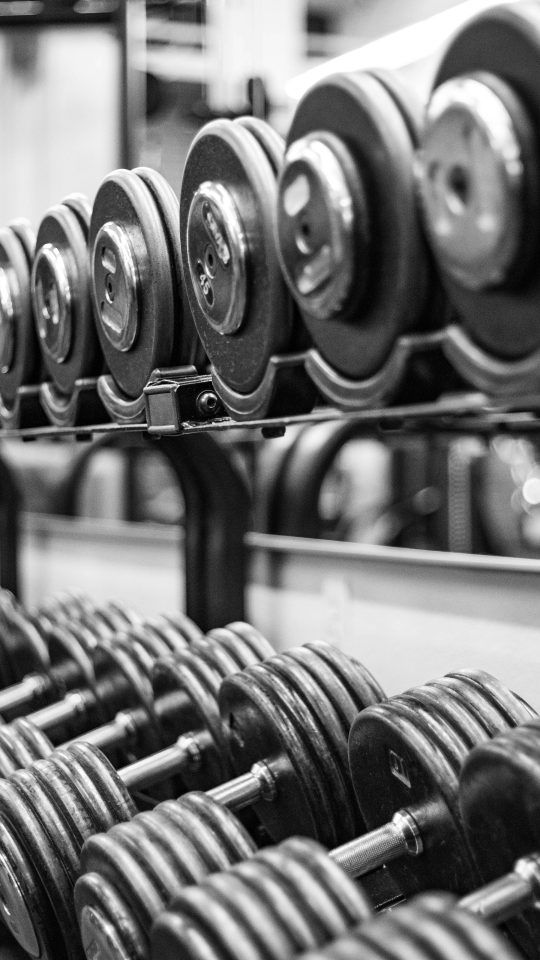 gray scale photo of dumbbells