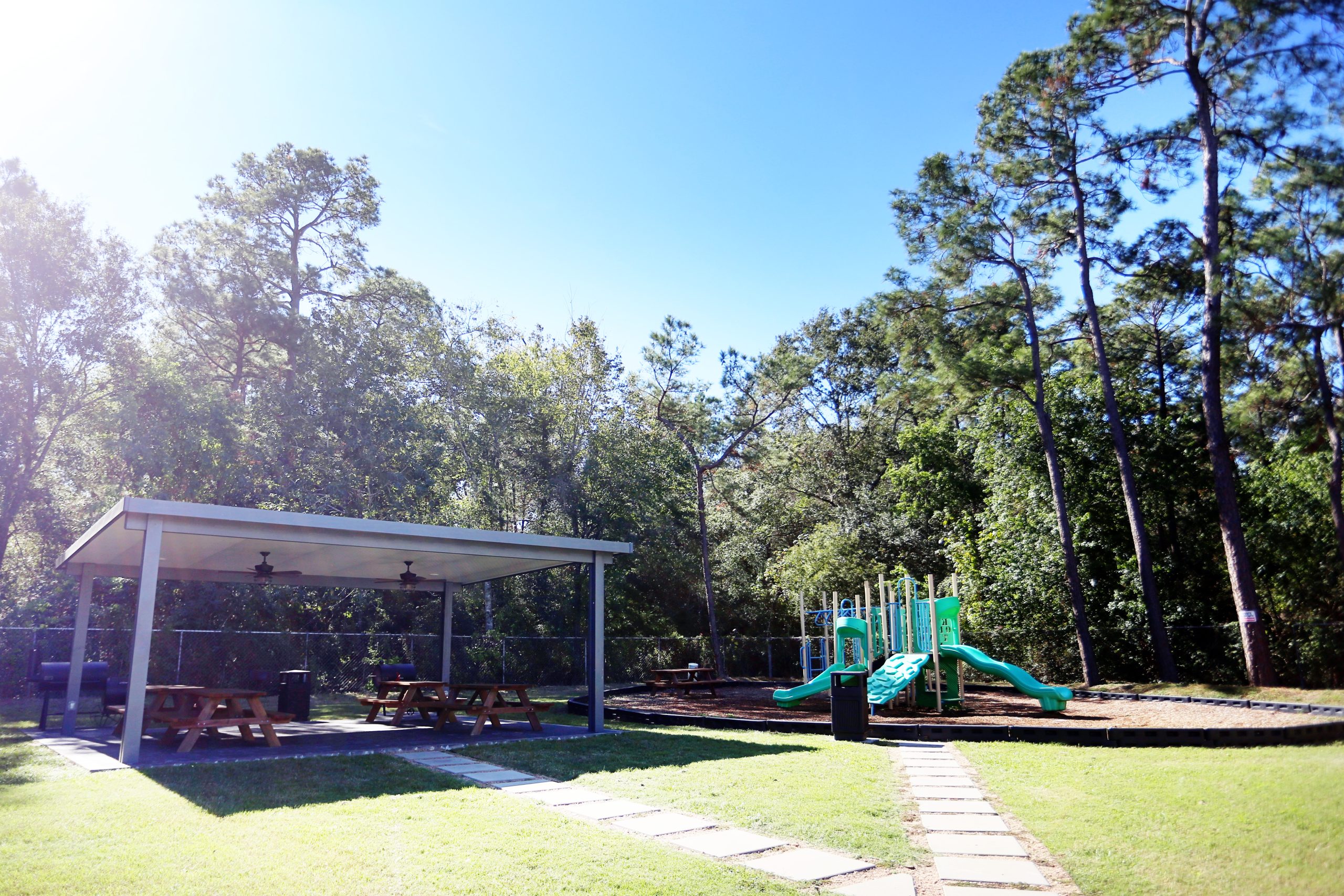 a playground area with a covered shelter and a picnic table at The Wilson Place 